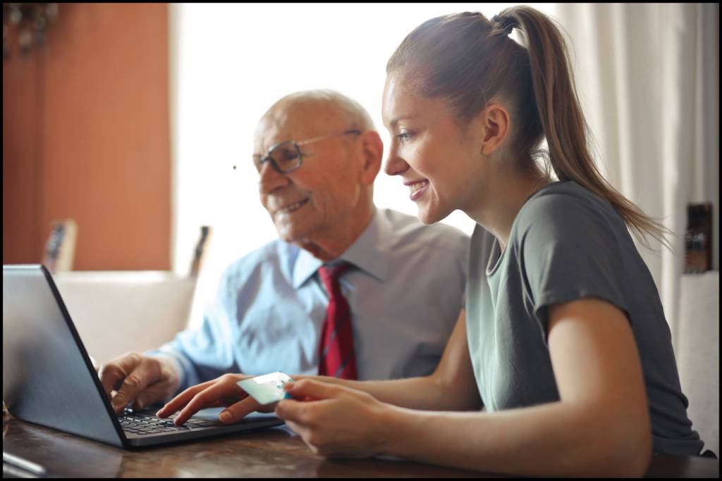 Two people looking at a laptop