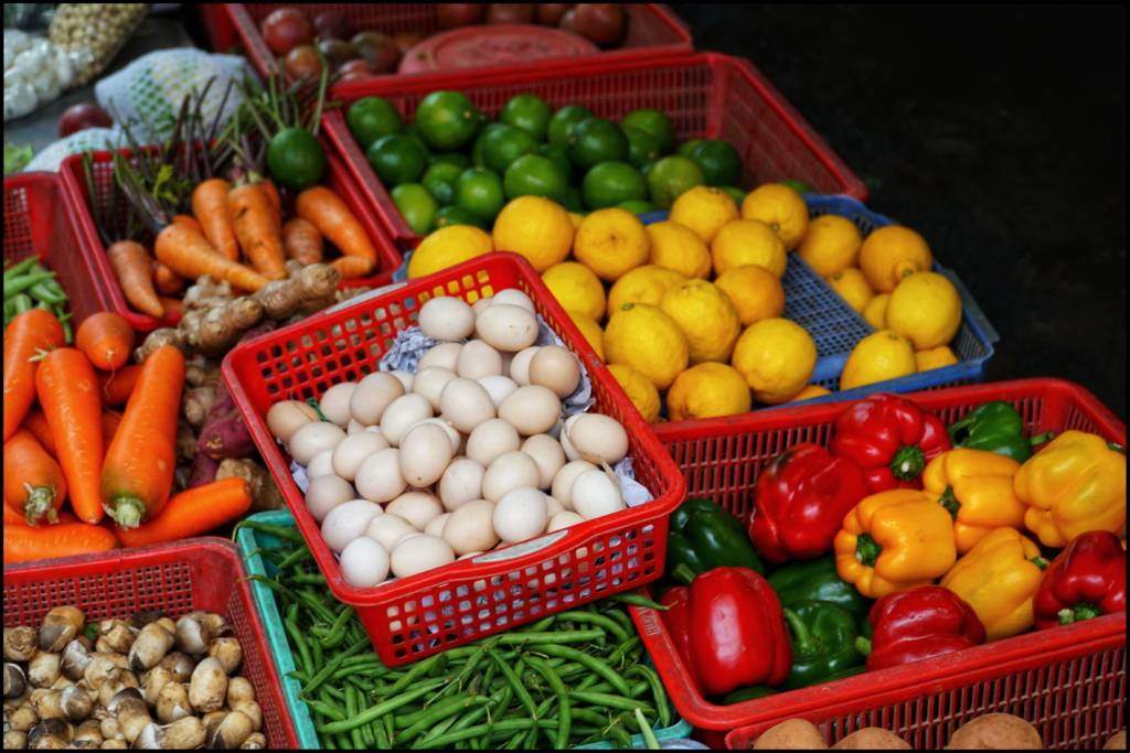 Baskets with fruits, vegetables, and eggs